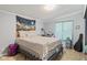 Neutral-toned bedroom features a tapestry above the bed and wood-look flooring at 48 W Adams Brick Ave, Martinsville, IN 46151