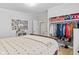 Bedroom with a large bed, closet with clothing, wood look floors and neutral paint at 48 W Adams Brick Ave, Martinsville, IN 46151