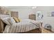 Well-lit bedroom offers wood-look flooring, a king bed, and convenient access to a full bathroom at 48 W Adams Brick Ave, Martinsville, IN 46151