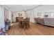 Inviting dining room with wood floors, ceiling fan, classic wooden dining set, and open access to the living room at 48 W Adams Brick Ave, Martinsville, IN 46151