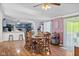 Spacious dining area features hardwood floors, an adjacent kitchen, and natural light from sliding glass doors at 48 W Adams Brick Ave, Martinsville, IN 46151
