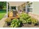 Inviting front porch with stylish outdoor seating and beautiful landscaping at 48 W Adams Brick Ave, Martinsville, IN 46151