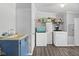 Laundry room with blue lower cabinets, washer, dryer and wood look floors at 48 W Adams Brick Ave, Martinsville, IN 46151