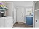 Laundry room with washer, dryer, blue cabinets and dark wood look floors at 48 W Adams Brick Ave, Martinsville, IN 46151