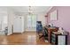 Home office with wood-look flooring, a vintage wooden desk, and great natural light from the large window at 48 W Adams Brick Ave, Martinsville, IN 46151