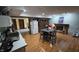 Partially finished basement with a fireplace, dining table, kitchenette, and hardwood-style flooring at 492 Pelenor Dr, Franklin, IN 46131