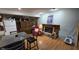 Partially finished basement with a fireplace, dining table, kitchenette, and hardwood-style flooring at 492 Pelenor Dr, Franklin, IN 46131