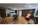 Partially finished basement with a fireplace, dining table, kitchenette, and hardwood-style flooring at 492 Pelenor Dr, Franklin, IN 46131
