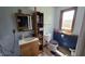Bright bathroom boasts a wood vanity, toilet, painted accent wall, and storage shelving at 492 Pelenor Dr, Franklin, IN 46131