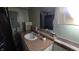 Cozy bathroom has tile backsplash, spacious sink, and mirror, plus a sauna in the reflection at 492 Pelenor Dr, Franklin, IN 46131