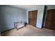 Bedroom view with neutral paint, and empty crib and a dark wooden closet at 492 Pelenor Dr, Franklin, IN 46131