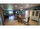 Large, open dining room featuring hardwood floors, decorative wallpaper, and access to outdoor deck at 492 Pelenor Dr, Franklin, IN 46131