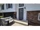 Welcoming front entrance features a gray front door, brick accent wall, and a cozy bench at 492 Pelenor Dr, Franklin, IN 46131