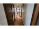 Hallway with wood floors and dark wood trim with a view into another room at 492 Pelenor Dr, Franklin, IN 46131