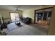 Comfortable living room features neutral carpet, ceiling fan, and glass sliding doors to backyard deck at 492 Pelenor Dr, Franklin, IN 46131