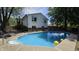 Backyard with a refreshing in-ground pool, surrounded by a concrete deck and mature trees at 492 Pelenor Dr, Franklin, IN 46131