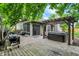 Inviting back deck featuring a pergola, hot tub, grill, and partially screened porch at 497 Pebble Way, Greenwood, IN 46142
