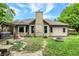 Backyard with mature trees, fire pit, and patio with a hot tub at 497 Pebble Way, Greenwood, IN 46142