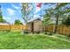 Fenced backyard with storage shed and an American flag at 497 Pebble Way, Greenwood, IN 46142