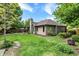 Green backyard featuring mature trees, hot tub, fire pit, and privacy fence at 497 Pebble Way, Greenwood, IN 46142