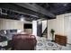 Finished basement with a comfortable seating area, television, and open ceiling at 497 Pebble Way, Greenwood, IN 46142