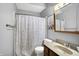 Bathroom with a stylish vanity, toilet, shower curtain and humorous framed artwork at 497 Pebble Way, Greenwood, IN 46142
