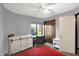 Bright bedroom with a desk, modern dresser, ceiling fan, closet, and ample natural light at 497 Pebble Way, Greenwood, IN 46142