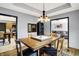 The dining room features a tray ceiling and is open to the kitchen at 497 Pebble Way, Greenwood, IN 46142