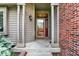 Inviting front porch with decorative door and sidelights flanked by brick and wooden siding at 497 Pebble Way, Greenwood, IN 46142