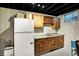 Functional kitchenette area with cabinets, sink, and refrigerator, perfect for small spaces at 497 Pebble Way, Greenwood, IN 46142