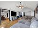 Open living area with hardwood flooring, comfortable sectional sofa, and access to the dining room at 497 Pebble Way, Greenwood, IN 46142