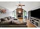 Sun-filled living room with beautiful brick fireplace, hardwood floors, and a comfortable sectional sofa at 497 Pebble Way, Greenwood, IN 46142
