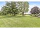 Expansive backyard with lush green grass and mature trees, providing ample space for outdoor enjoyment at 523 Torrey Ct, Avon, IN 46123