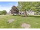 Expansive backyard featuring lush green grass and mature trees, perfect for outdoor enjoyment at 523 Torrey Ct, Avon, IN 46123