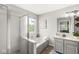 Bright bathroom featuring a bathtub with jets, a window view, and a glass door shower at 523 Torrey Ct, Avon, IN 46123