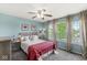 Comfortable bedroom with a plush bed, ceiling fan, and abundant natural light from the windows at 523 Torrey Ct, Avon, IN 46123