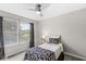 Bedroom with two bright windows, a lamp, and a bed with stylish patterned bedding at 523 Torrey Ct, Avon, IN 46123