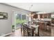 View of the dining room with a sliding glass door that views the beautiful outdoor area and an adjacent kitchen at 523 Torrey Ct, Avon, IN 46123