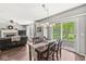Bright dining room with wood floors, modern chandelier, and sliding glass doors to a beautiful outdoor area at 523 Torrey Ct, Avon, IN 46123