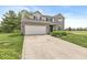 Charming two-story home with a brick facade, attached garage, and well-manicured lawn at 523 Torrey Ct, Avon, IN 46123