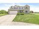 Attractive two-story home with a spacious driveway, brick accents, and manicured landscaping at 523 Torrey Ct, Avon, IN 46123