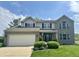 Traditional two-story home with a gray brick facade, well-manicured lawn, and an attached two-car garage at 523 Torrey Ct, Avon, IN 46123