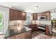 Modern kitchen with dark wood cabinets, granite countertops, and stainless steel appliances at 523 Torrey Ct, Avon, IN 46123