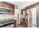 Kitchen with stainless steel appliances, dark cabinets, and a mosaic tile backsplash at 523 Torrey Ct, Avon, IN 46123