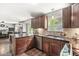 Well-lit kitchen featuring dark wood cabinetry, granite countertops, and stainless steel appliances at 523 Torrey Ct, Avon, IN 46123