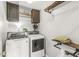 Functional laundry room with modern appliances, storage shelves, and industrial style hanging racks at 523 Torrey Ct, Avon, IN 46123