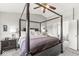 Main bedroom with dark furniture, a four-poster bed, ceiling fan, and attached bathroom at 523 Torrey Ct, Avon, IN 46123