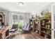 Bright office space with hardwood floors, a large bookcase, and two comfortable chairs at 523 Torrey Ct, Avon, IN 46123