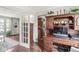Office featuring hardwood floors, built-in shelving, and a view into an adjacent living space at 523 Torrey Ct, Avon, IN 46123