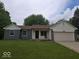 Traditional home with a well-manicured lawn and an attached two-car garage, showcasing suburban living at 6006 Buell Ln, Indianapolis, IN 46254